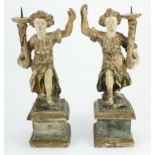 Candlesticks. A pair of carved figural candlesticks, height 32.5cm approx.