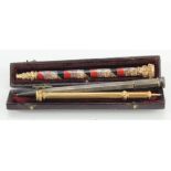 Three propelling pencils, consisting of two yellow metal examples including one in morocco leather