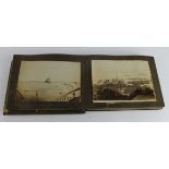 Distressed black lacquer concertina album housing a photographic collection (not postcards) of HMS