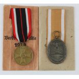 German West Wall medal with German war merit medal both in packets of issue.