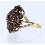9ct yellow gold cluster ring, set with oval and round cut garnets, finger size V, weight 6.3g.