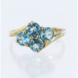 9ct yellow gold blue topaz four stone ring, finger size P, weight 2.7g