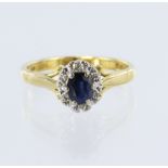 18ct yellow gold sapphire and diamond cluster ring, sapphire measuring approx. 5mm x 4mm, surrounded