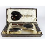 Boxed six piece silver and tortoiseshell dressing table set comprising of two hair brushes, two