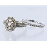 9ct white gold diamond cluster ring with matching wedding ring. Cluster comprising a central round