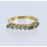 18ct yellow gold half eternity ring set with five baguette cut emeralds measuring approx. 3mm x 1.