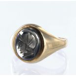 9ct yellow gold signet ring set with a carved oval haematite measuring approx. 12mm x 10mm, finger