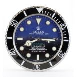 Advertising Wall Clock. Blue 'Rolex' style advertising wall clock, black & blue dial reads 'Rolex