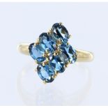 9ct yellow gold ring set with six oval blue topaz measuring approx. 6mm x 4mm, finger size T, weight