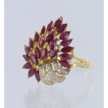 Tests 18ct yellow gold ring set with 23 marquise cut rubies, highlighted with diamond points.