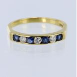 18ct yellow gold seven stone channel set ring, set with four round sapphires and three round