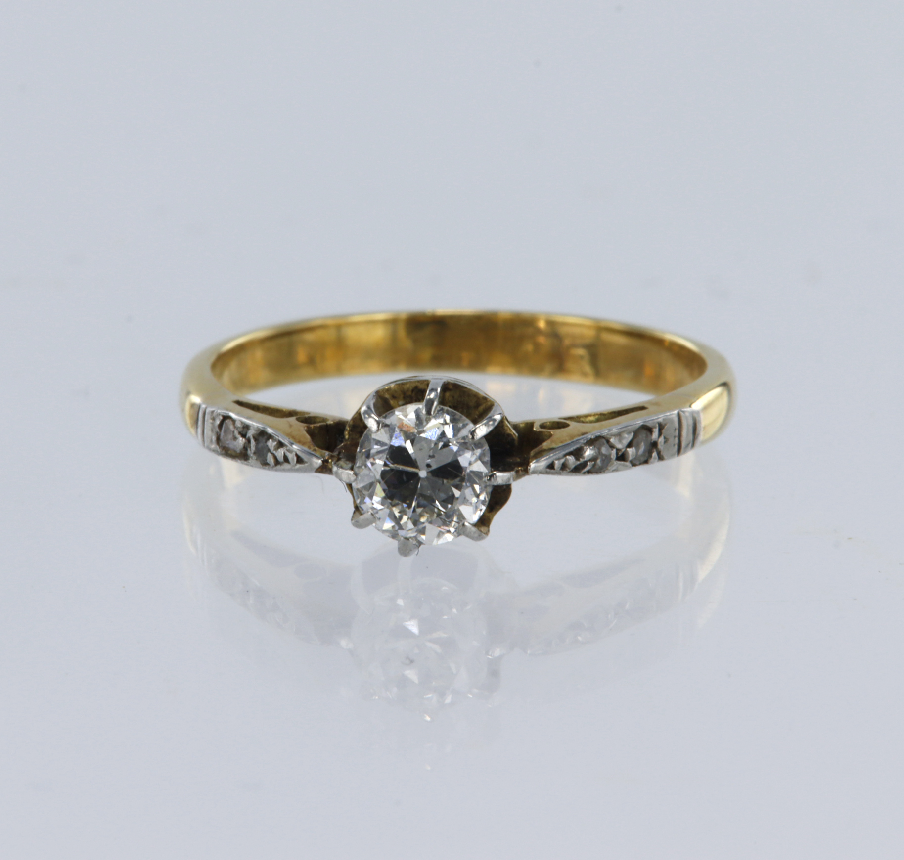 Yellow metal tests 18ct, diamond soliatire with supporting diamond shoulders, principle old cut