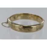 9ct bangle with safety chain, hallmarked Birmingham 1976. Weight 19.7g