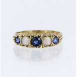 9ct yellow gold carved head ring set with three graduated sapphires and two opal cabochons, finger