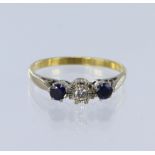 18ct yellow gold trilogy ring set with a central round brilliant cut diamond in an illusion setting,