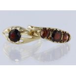 Two garnet rings to include 9ct yellow gold solitaire ring in gypsy setting, stone measures 7mm in