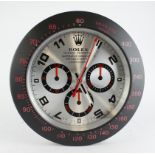 Advertising Wall Clock. Matt black and silver 'Rolex' style advertising wall clock, white dial reads