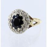 9ct yellow gold cluster ring set with a central oval sapphire measuring approx. 9mm x 7mm surrounded