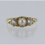 Yellow metal (tests 18ct) half pearl and diamond boat shaped trilogy ring, half pearl measures 5.
