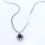 18ct white gold necklace featuring a central oval sapphire measuring approx. 7mm x 6mm, surrounded