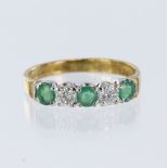 9ct yellow gold half eternity ring set with three round emeralds and two brilliant cut diamonds,