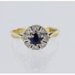 18ct yellow gold cluster ring, set with a sapphire, diameter measuring 4mm, surrounded by 8