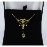 18ct yellow gold art nouveau styled peridot, seed pearl and enamelled pendant, two pear cut