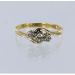 18ct yellow gold and platinum three stone graduated diamond crossover style ring, total diamond