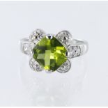 18ct white gold ring set with a cushion shaped chequerboard cut peridot measuring approx. 10mm x