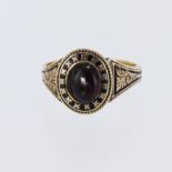 Tests 14ct, date hallmark 1835, mourning ring, set with a cabochon garnet measuring 8mm x 6mm with