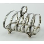Attractive, unusual silver toast rack on four scroll feet; hallmarked JW&Co. 1937. Weighs approx.