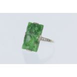 Tests 9ct white gold ring, carved retangular jade , measuring approx 19mm x 10mm with supporting