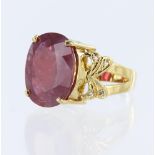 18ct yellow gold dress ring set with an oval glass filled ruby measuring approx. 17mm x 15mm, with