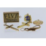 Assortment of pendants and charms to include 9ct yellow gold five pound charm. 9ct yellow gold cross