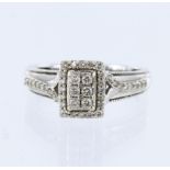 9ct white gold ring with rectangular shaped head set with six round brilliant cut diamonds, framed
