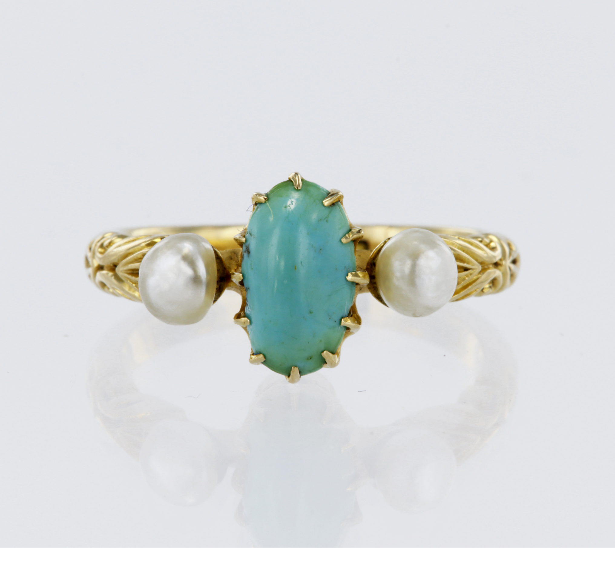 Stamped 18CT yellow metal turquoise and pearl trilogy ring, flanked with engraved shoulders,