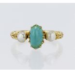 Stamped 18CT yellow metal turquoise and pearl trilogy ring, flanked with engraved shoulders,