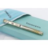 Tiffany & Co silver cased ballpoint pen, the clip inscribed "T & Co 925 1837. With blue Tiffany