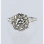 White metal stamped 'PLAT' diamond daisy cluster ring, principle round brilliant cut diamond
