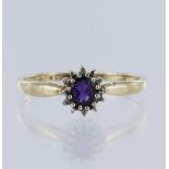9ct yellow gold cluster ring, set with one oval mixed cut deep purple amethyst measuring 5mm x 4 mm,