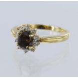 18ct yellow gold diamond cluster ring, principle oval brilliant cut fancy cognac diamond originating