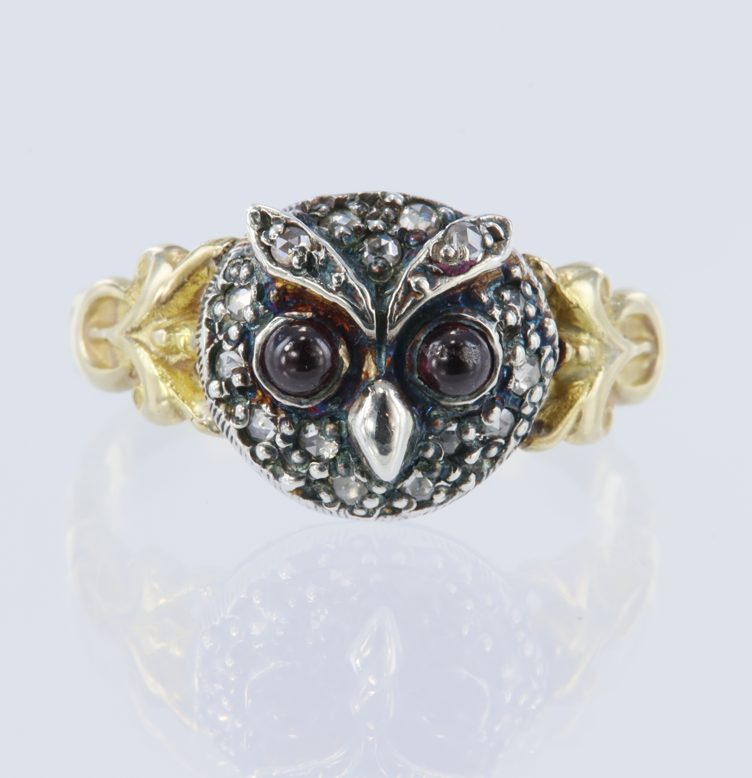 Yellow gold (tests 14ct) owl ring, set with cabochon garnet eyes measuring 2.5mm each, surrounded
