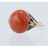 Yellow gold (tests 12ct) antique coral ring, circular coral cabochon measures 16mm, flanked with a