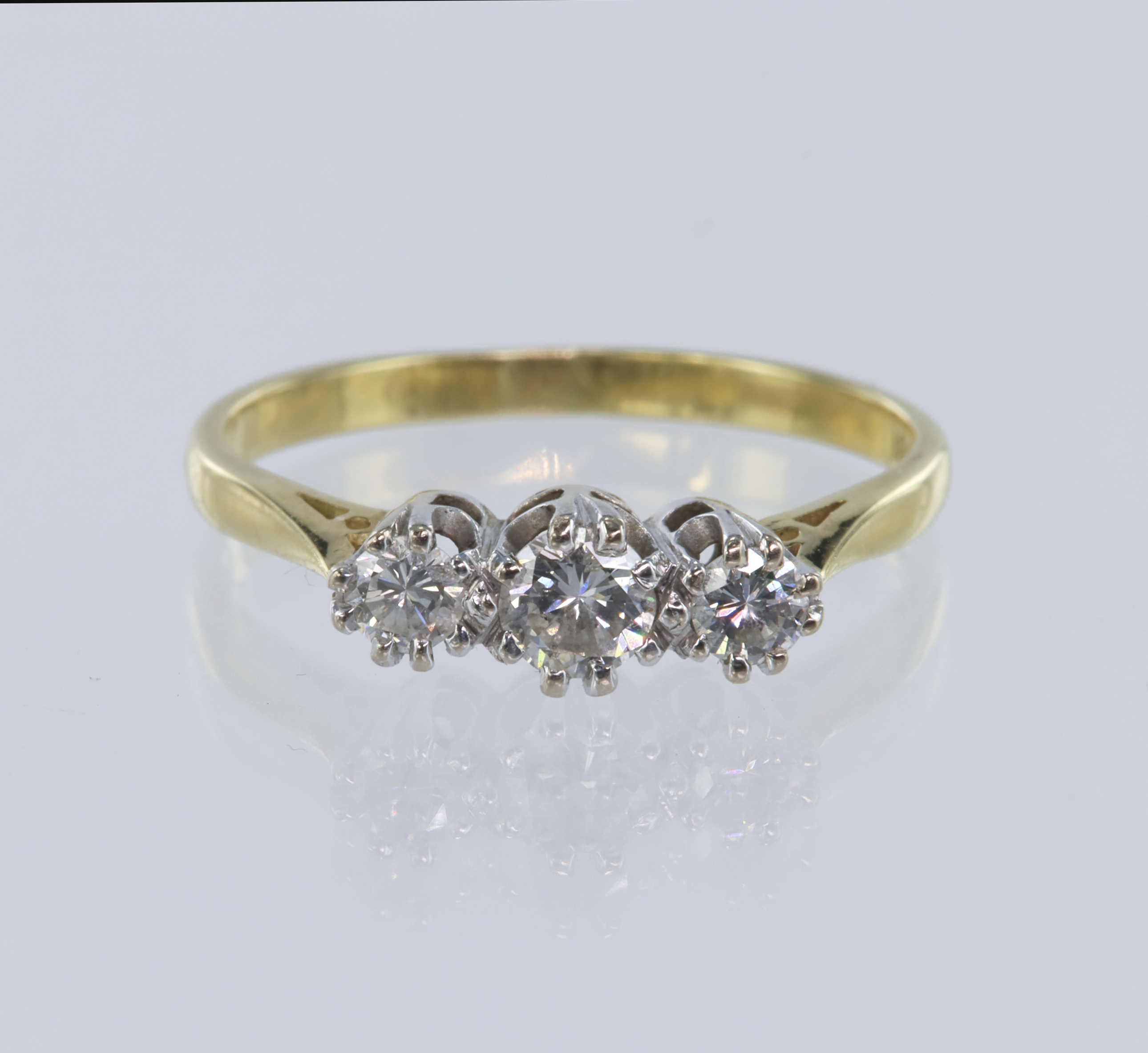 Yellow gold (tests 18ct) trilogy ring, set with three graduating round brilliant cut diamonds, total