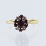 Yellow gold (tests 18ct) ruby and diamond cluster ring, principle oval mixed cut ruby measures 5mm x