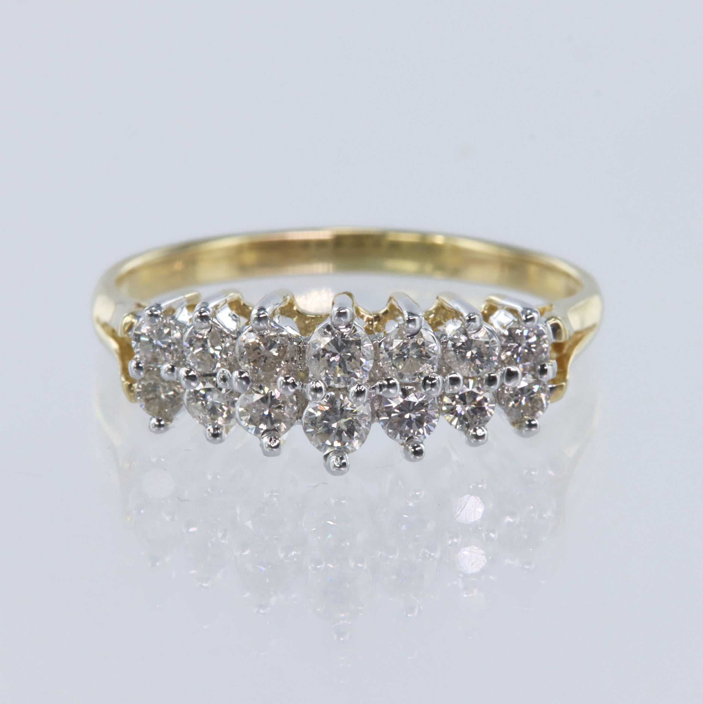 Yellow gold (tests 14ct) diamond set dress ring, set in two rows with a total of fourteen graduating