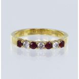 18ct yellow gold diamond and ruby seven stone eternity ring, set with three round brilliant cut