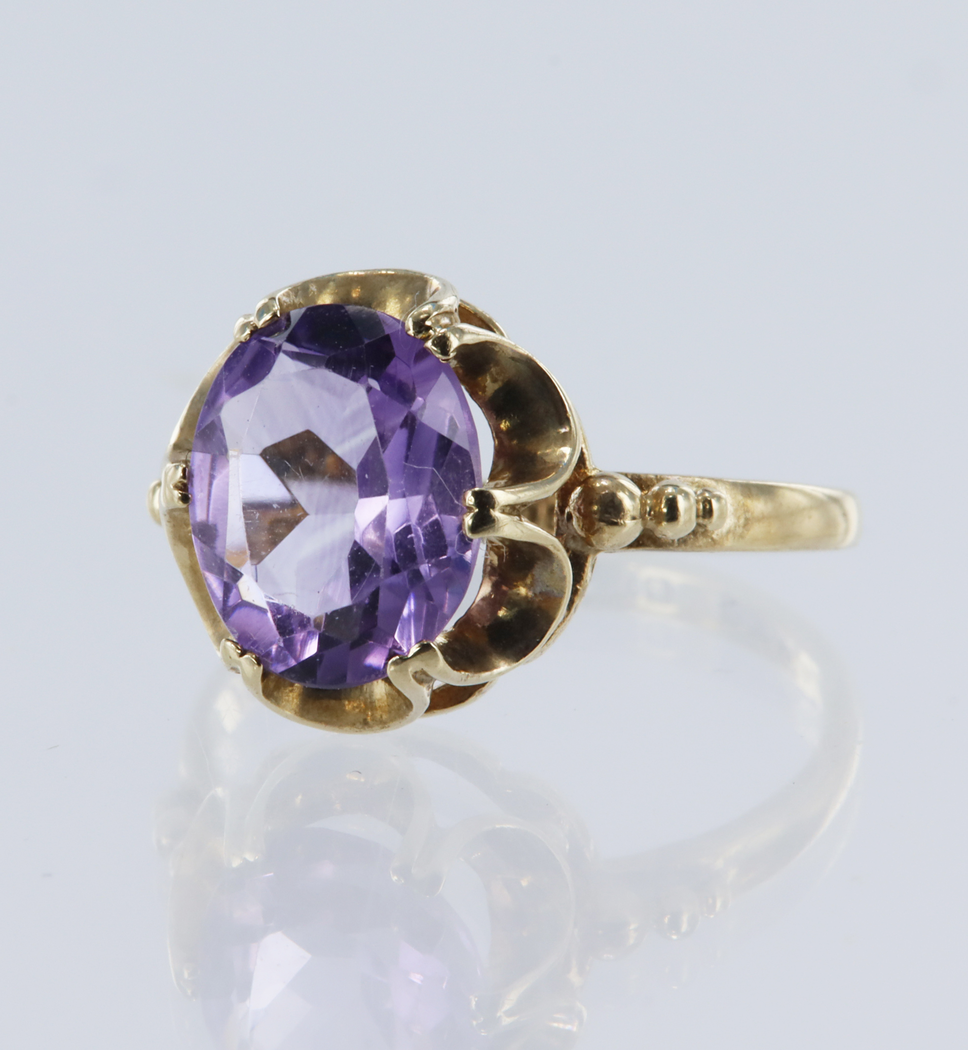 9ct yellow gold amethyst dress ring, set with one oval mixed cut amethyst measuring 10mm x 8mm,