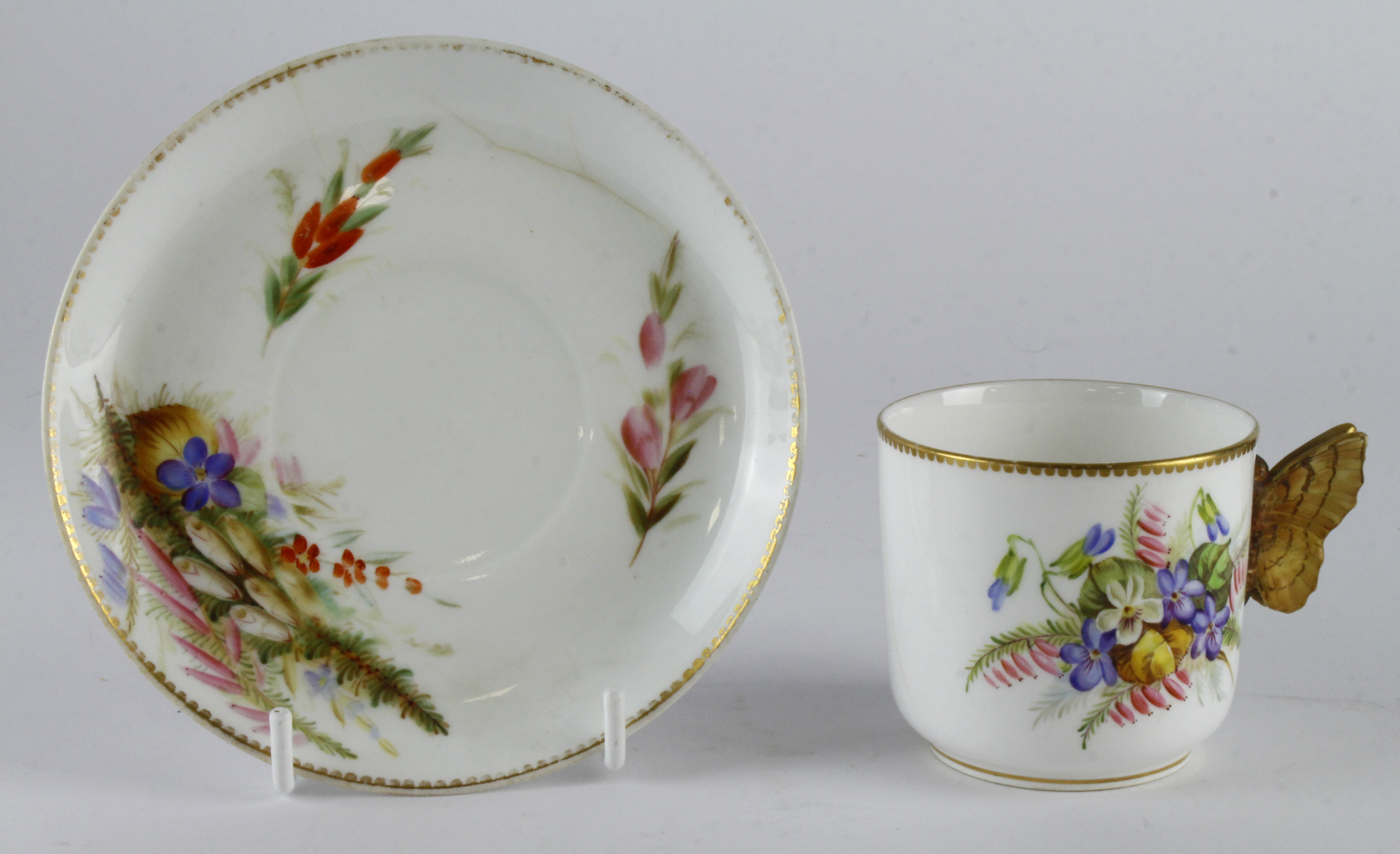 Royal Worcester cup and saucer, hand painted floral decoration with butterfly handle to cup,