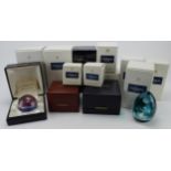 Caithness. A collection of approximately fourteen boxed Caithness glass paperweights, including some